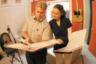 John LeBlanc, left, and vocalist Leila Wathen share music notes during a Feb. 19 recording session in Peachtree City.