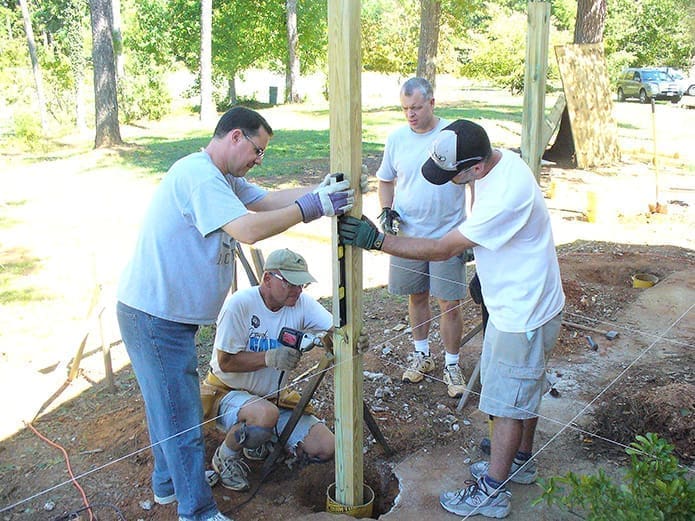 Volunteers help rebuild a ramp at St. Michael the Archangel Church, Woodstock. It was part of an Eagle Scout project by parishioner Brennan Kellner.