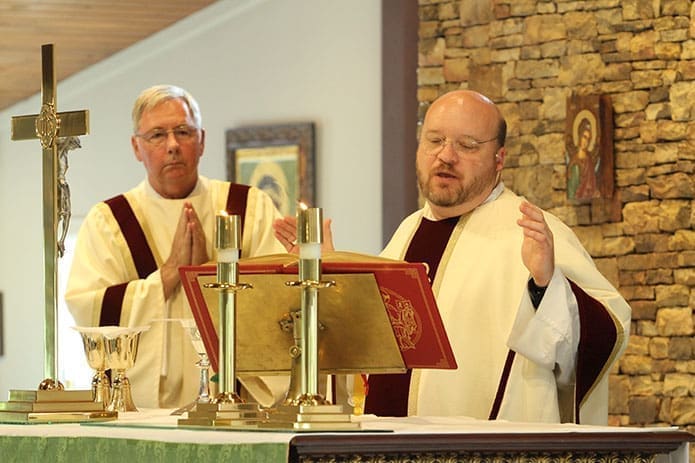 Father Charles Byrd, right, pastor of Our Lady of the Mountains Church, Jasper, is the main celebrant for a June 24 Mass for Religious Freedom at his parish. Joining him on the altar is Deacon Lloyd Sutter.