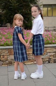 Clare DiBiase, right, keeps a close eye on her younger friend, Lizzie Nevin, as part of Christ the King School’s Guardian Angel program for new primary grade students.