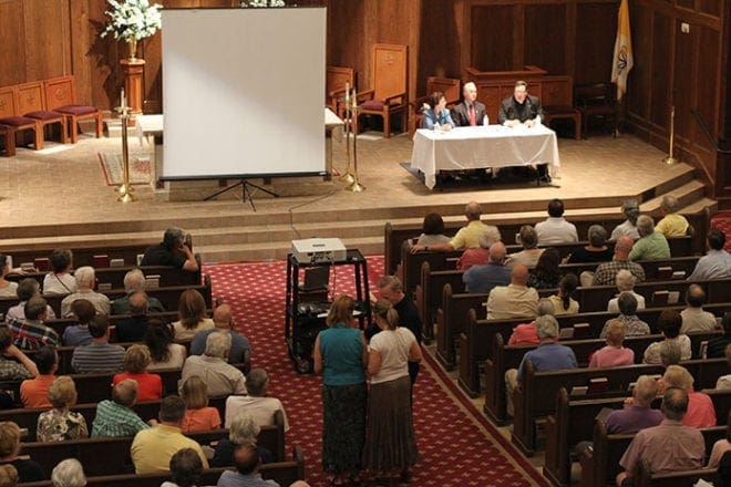 After their respective talks (l-r) Mary Boyert, archdiocesan Respect Life director, Congressman Tom Price, M.D., representative from Georgia's 6th Congressional District, and Father Joshua Allen, parochial vicar at St. Brigid Church, Johns Creek, take written questions from the audience, which were read by St. Brigid pastor Father Neil Herlihy. Photo By Michael Alexander 