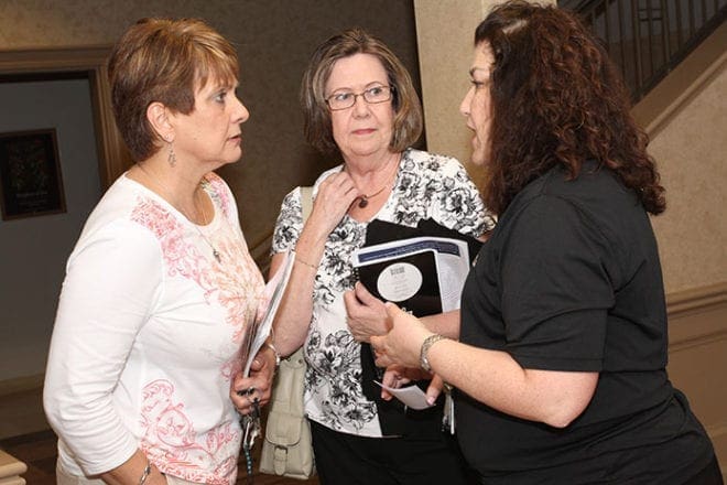 Joanne Minster and Lynn Sands of St. Ann’s Church, Marietta, converse with Daisy Davidow of St. Brigid Church following the informational forum on the HHS mandate and religious liberty. Photo By Michael Alexander 
