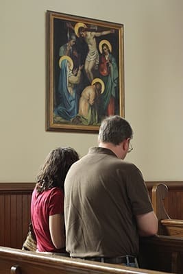 Christine Zimmerman, left, of St. Brigid Church, Johns Creek, and Edward Kujawski of Our Lady of the Assumption Church, Atlanta, pray the Stations of the Cross on Kujawski’s smart phone at the Shrine of the Immaculate Conception Church, Atlanta. Since it was the vigil of the birth of Mary, the young adults wanted to attend the Sept. 7 Day of Fasting and Prayer for Peace in Syria, the Middle East, and throughout the world at a Marian shrine. They also took time to pray the rosary. Photo By Michael Alexander