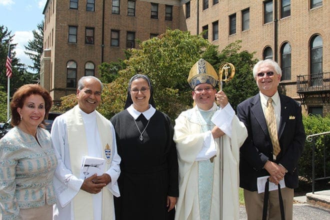 Sister Sophia Marie’s parents, Maria Cabrera, left, and Fernan J. Peralta, right, are shown with the celebrant of the Mass of profession, Bishop Manuel Cruz, auxiliary bishop of Newark, N.J., and Father Joseph Mullakkara, MSFS, one of several clergy to attend the Mass from the Atlanta Archdiocese.