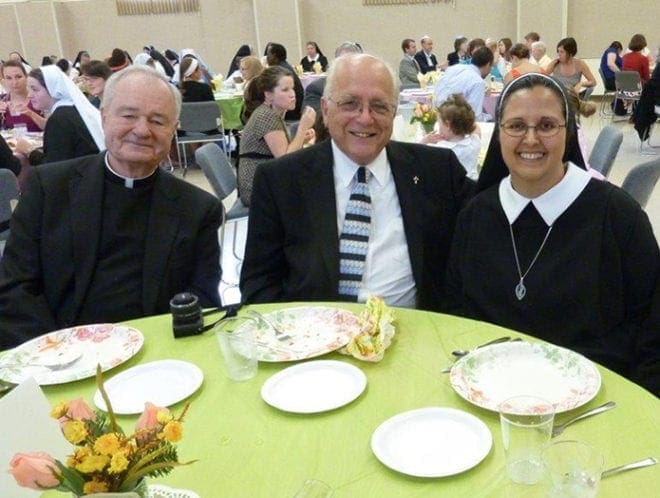 Father Richard Morrow, left, and Deacon Whitney Robichaux, center, both serving at the Cathedral of Christ the King in Atlanta, celebrate with Sister Sophia Marie on her profession as a consecrated religious.