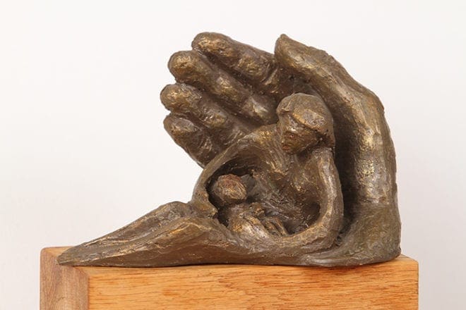 In addition to oil and acrylic paintings, Josef Mahler also works with ceramics. This bronze-colored ceramic piece is entitled “In God’s Hands.” Photo By Michael Alexander