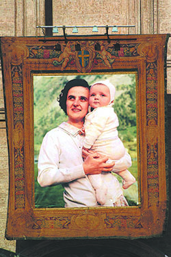 A tapestry depicting St. Gianna Beretta Molla hung from the front of St. Peter’s Basilica during her 2004 canonization Mass. Pope John Paul II created six new saints, including Molla, an Italian laywoman and physician referred to as the pro-life saint. CNS photo by Daniele Colarieti