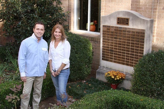 (L-r) Jaime Fernando Ochoa and Ellen Cocks stand in Amelia Mary Memorial Garden on All Souls Day at Holy Spirit Church, Atlanta. The cremated remains of Ochoa’s mother Mariella Hoyos De Ochoa and Cocks' daughter Grace reside in the garden. Photo By Michael Alexander