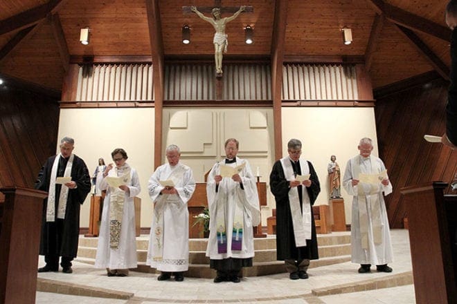 (L-r) Dr. Don Martin, senior pastor, Alpharetta First United Methodist Church, Rev. Cynthia Park, assistant rector, St. Aidan’s Episcopal Church, St. Thomas Aquinas deacon Ed LaHouse, Rev. Robert Wood, rector, St. Aidan’s Episcopal Church, Dr. Ollie Wagner, senior pastor, Alpharetta Presbyterian Church, and Father Austin Fogarty, pastor, St. Thomas Aquinas Church, gather in front of the altar during a litany of thanksgiving. The six clergy from four Alpharetta community churches came together for the fifth annual ecumenical Thanksgiving service, Nov. 17. 