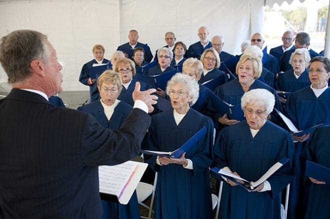 Art Hargrove directs choir members from Christ Our King and Savior Church, Greensboro, at the blessing of the new hospital facility, which serves Greene County and the Lake Oconee area. Peter Faletti, music director, accompanied the choir. Photo by Dennis McDaniel