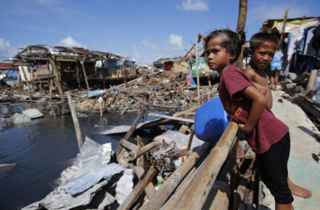 A girl looks on in the devastated waterfront shanty town of Guiuan, Philippines, Nov. 19, in the aftermath of Typhoon Haiyan. Ten days after one of the most powerful typhoons ever recorded, some residents of remote villages where the storm made landfall in the central Philippines, said they were still waiting for aid. CNS photo/Wolfgang Rattay, Reuters 
