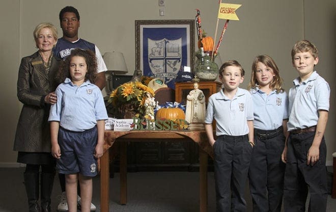 (L-r) Sophia Academy founder Marie Corrigan stands in the school’s lobby with eighth-grader Keenan Tinsley, second-grader Kaylee Miles, first-graders Nicholas McInaney and Anna Miles and fourth-grader Ben Thomas. After a 22-month process, the Atlanta academy recently attained its designation as an independent Catholic school. Photo By Michael Alexander