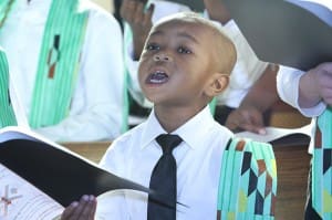 Three-year-old Toritsé Edun only stands three feet, two inches, but he stood tall when it came to singing with fellow children choir members during the annual Martin Luther King Jr. Eucharistic Celebration. Photo By Michael Alexander