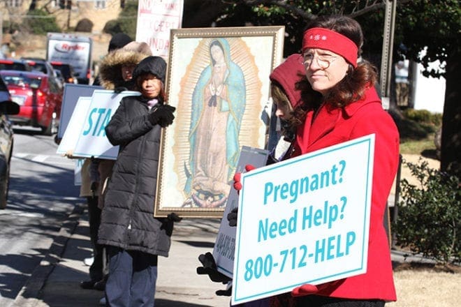 Jean Larson, foreground right, of St. Michael the Archangel Church, Woodstock, stands along Peachtree Road with other participants during the Jan. 22 Stand For Life. Photo By Michael Alexander
