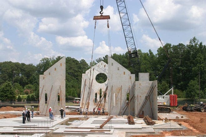 Crane operator Corey DeLoach lifts the concrete panel that today holds St. Peter Chanel Church’s rose window. Construction of the church was completed in 2008 and it was dedicated in November of that year. The 33,361-square-foot church has occupancy for nearly 1,300 people. Photo By Michael Alexander