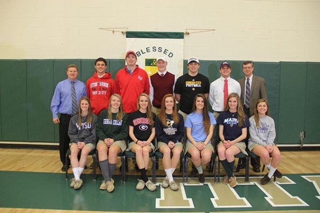 On Feb. 5 Blessed Trinity High School athletic director Ricky Turner, standing far left, and principal Frank Moore, standing far right, join the school’s National Signing Day student athletes (back row, l-r) Marc Nolan, Trey Caso, Chris Keegan, Zach Mitchler, Carter McManes; (front row, l-r) Cameron Cox, Meredith Carson, Anna Gandolfo, Shannon Innis, Angela Bringmann, Amy Falkin and Bailey Willett.