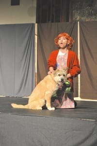 Isabella Marquez performs the lead role of Annie during the parish performance of the musical hit, “Annie Jr.” The dog Crash, who played Sandy, is a certified therapy dog with Therapy Dogs International. The sold-out performances in February brought fans to watch the drama ministry at St. Oliver Plunkett Church, in Snellville.