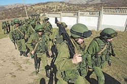 Military personnel, believed to be Russian servicemen, walk in formation outside a Ukrainian military base in Perevalnoye, Ukraine, March 3. The head of the Ukrainian Catholic Church said Ukrainians must be prepared "to sacrifice our lives in order to protect the sovereign, free, independent, and unified state." CNS photo/David Mdzinarishvili, Reuters