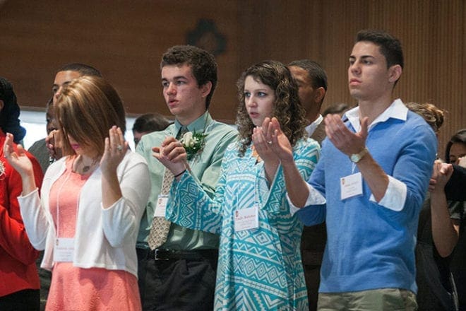 Outstanding youth of the year pray the Our Father at the AACCW Recognition Day Mass. Shown (l-r) are Kameron Adair, St. Oliver Plunkett Church, Snellville; Joshua Brand, Transfiguration Church, Marietta; Emily Bottchen, Christ Our King and Savior Church, Greensboro; and Josue Araya, St. George Church, Newnan. Photo by Thomas Spink