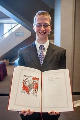 Patrick Klein, adult education director at St. Monica Church, Duluth, holds his parish’s Book of the Elect. Photo by Thomas Spink
