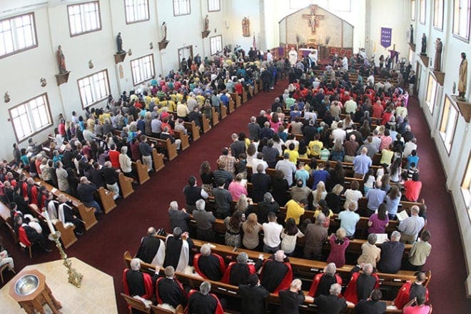 St. Michael the Archangel parishioners gather in their existing church for a special Mass that preceded the March 8 groundbreaking for a new church. The Woodstock parish has over 2,800 registered families. Photo By Michael Alexander