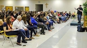 Chris Sandy speaks to teens and families at St. Pius X Church, Conyers, on March 2. He served over eight years in prison for causing a DUI accident, which killed an elderly couple. In a program called “Enduring Regret,” he now tells his story in an effort to prevent others from experiencing such sorrow and tragedy. He speaks with Eric Krug, who was severely injured as a passenger in a separate accident. Photo by Lee Depkin