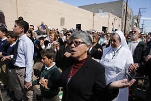 People pray during Mass celebrated by a group of U.S. bishops at the border fence in Nogales, Ariz., April 1. The bishops were on a two-day visit to the U.S. border with Mexico calling attention to the plight of migrants and appealing for changes in the U.S. immigration system. CNS photo/Nancy Wiechec