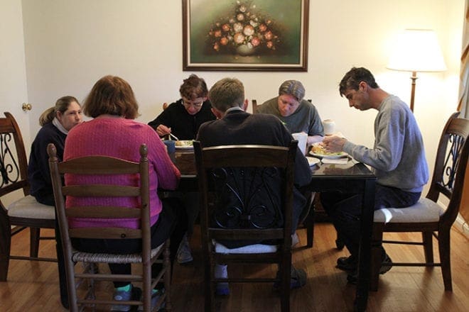 Six of the St. Mary's Independent Living Extensions' clients come together for their weekly life skills class and communal meal at the independent living site in Tucker. Photo By Michael Alexander