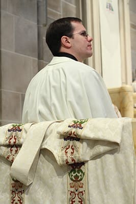 Brian Bufford listens as Archbishop Wilton D. Gregory addresses the transitional diaconate candidates and the congregation during his homily. Photo By Michael Alexander