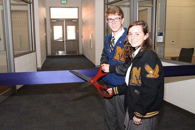 Student Council co-presidents Christopher Bowman, left, and Katie Hearn, members of the Marist 2014 senior class, had the honor of cutting the ceremonial ribbon during the May 20 dedication of Marist School’s Ivy Street Center, which marked its official opening.