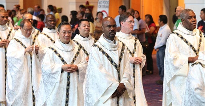 Archdiocesan and visiting clergy join the procession into the main hall of the Georgia International Convention Center for the closing Mass of the Eucharistic Congress. Photo By Michael Alexander