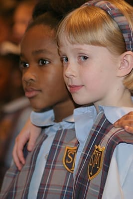 This photo appeared on page one of the January 22, 2004 issue of The Georgia Bulletin. St. Thomas More School kindergarteners Gabrielle Bowen, left, and Kelly Pickard were singing "Woke Up This Morning With My Mind Set on Jesus" with fellow students during the Dr. Martin Luther King Jr. Youth & Young Adult Celebration at the Shrine of the Immaculate Conception, Atlanta. Photo By Michael Alexander 