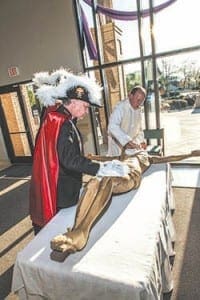 Grand Knight Mike Artzer of the Knights of Columbus St. Brendan Council 1294 and Legionary of Christ Father Matthew VanSmoorenburg, pastor of St. Brendan the Navigator Church in Cumming, prepare the corpus of Jesus for the blessing ceremony held in April. Photo by Larry Peterson