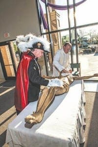 Grand Knight Mike Artzer of the Knights of Columbus St. Brendan Council 1294 and Legionary of Christ Father Matthew  VanSmoorenburg, pastor of St. Brendan the Navigator Church in Cumming, prepare the corpus of Jesus for the blessing ceremony held in April. Photo by Larry Peterson