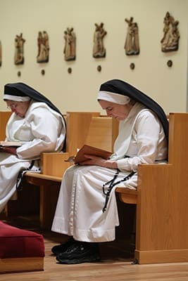 Hawthorne Dominican Sisters Carol Marie, foreground, and Mary Augustine, background, pray before the entire community of sisters does its daily morning office of prayers. Photo By Michael Alexander
