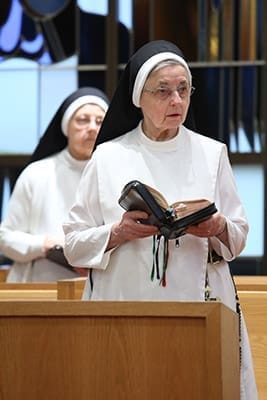 Hawthorne Dominican Sisters Mary Martha, foreground, and Mary Walter, background, stand as the intercessory prayers are read by the chaplain and the main celebrant for the morning Mass, Father Paul Burke. Sisters Mary Martha and Mary Walter have served at Our Lady of Perpetual Help Home for 12 and 19 years, respectively. Photo By Michael Alexander