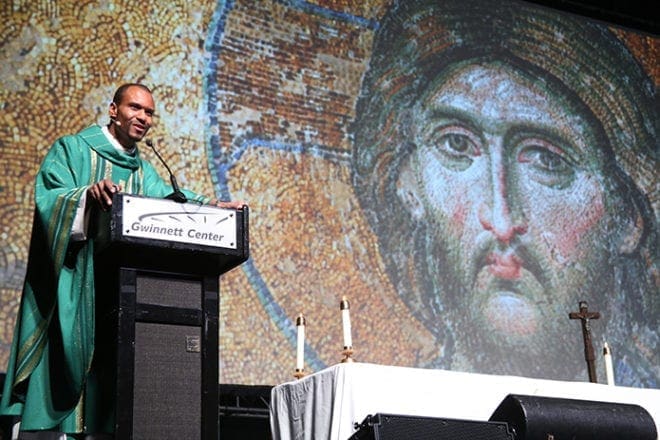 Haitian-born Father Louis Merosne served as the main celebrant and homilist for the July 12 Mass during the Steubenville Atlanta Conference at the Gwinnett Conference Center, Duluth. Photo By Michael Alexander