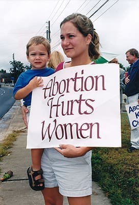 Jill Hoover holds her two-year-old son Peter during the Oct. 6, 2002 Life Chain on Johnson Ferry Road, Marietta. Photo By Michael Alexander