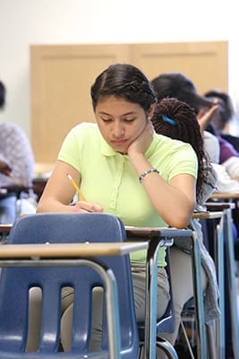 Fourteen–year-old Giselle Ayala, of Norcross, and the rest of the incoming freshman class at Cristo Rey Atlanta Jesuit High School, Atlanta, take a diagnostic placement test to assess their skills in areas like English, math and writing. Photo By Michael Alexander