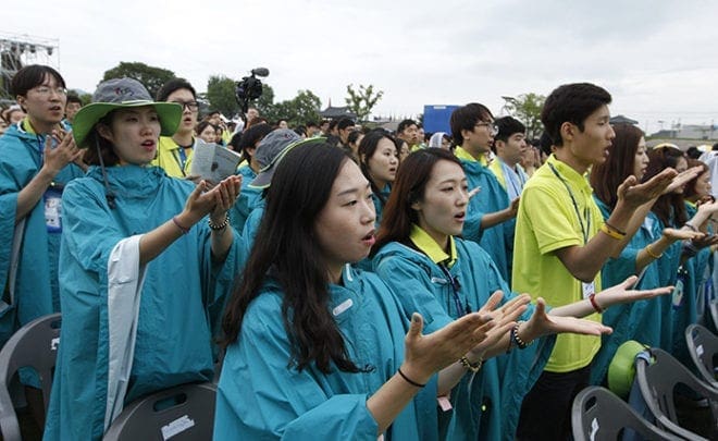 Young people pray as Pope Francis celebrates the closing Mass of the sixth Asian Youth Day at Haemi Castle in Haemi, South Korea, Aug. 17. CNS photo/Paul Haring