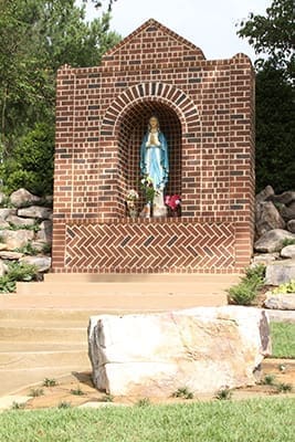 Everything for the new Our Lady of Lourdes grotto, except the statue, was donated through the generosity of parishioners. All the bricks, stone, landscaping material and labor that went into making the grotto served as a gift to the pastor, Father Richard Tibbetts. Father Fausto Marquez, the former parochial vicar, coordinated the project. Photo By Michael Alexander