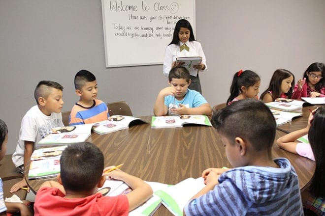 Bethy Ramirez-Sanchez, standing, teaches a third-grade catechism class with her older sister, Elizabeth, and one other instructor. The class is held on Wednesdays at her parish, St. Patrick Church in Norcross. Photo By Michael Alexander