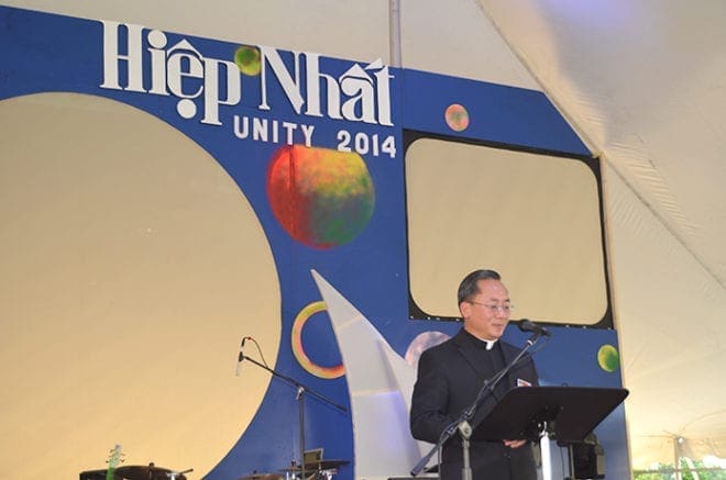 Father Francis Tran, pastor of Holy Vietnamese Martyrs Church, welcomes all to the Fall Festival at his parish. The theme of the event this year was unity. PHOTO BY CINDY CONNELL PALMER 