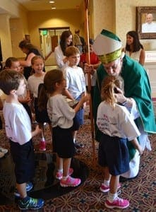 Bishop Luis R. Zarama warmly greets young students after celebrating Mass at St. Brigid Church, in Johns Creek, on Sept. 5. Holy Redeemer School opened 15 years ago and was celebrating its anniversary. 