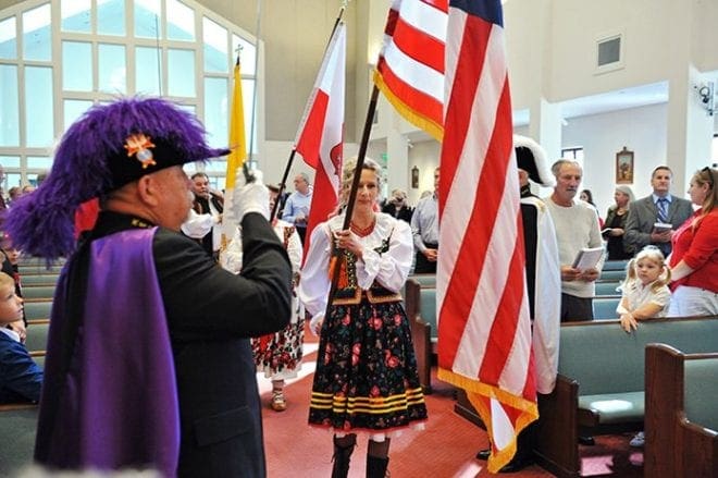 Anna Oberc, clad in her native Polish costume, processes into St. Marguerite d’Youville Church along with other parishioners at the start of the 25th anniversary Mass for the Atlanta Polish Catholic community. On hand were the Knights of Columbus to provide an honor guard. Photo by Lee Depkin