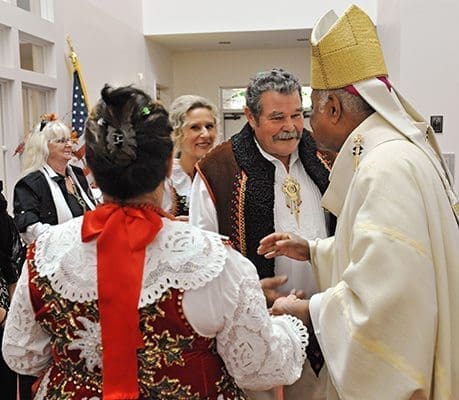 Archbishop Wilton D. Gregory greets members of the Atlanta Polish Catholic community Nov. 9. At the conclusion of the group’s anniversary Mass Archbishop Wilton D. Gregory read a proclamation formally changing the group’s name to the St. John Paul II Polish Catholic Apostolate. Here he talks to (l-r) Helena Wojdyla, Anna Oberc and Wladyslaw Wojdyla. Photo by Lee Depkin
