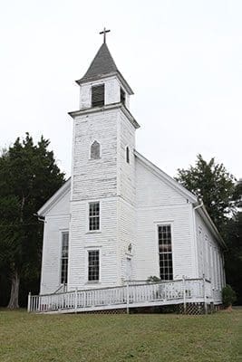 The current wooden frame Purification Church in Sharon was built in 1883, 82 years after Catholic settlers built the first church in Locust Grove, a mere log cabin. It is listed as an historic site “in peril.” More information can be found at www.savepurificationchurch.com. Photo By Michael Alexander