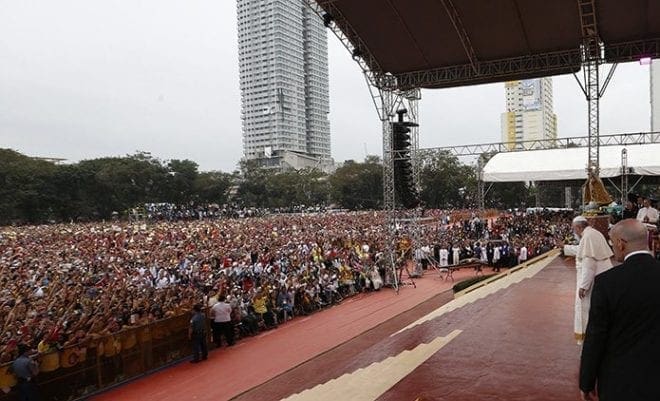 Pope Francis greets the crowd upon arriving for a meeting with young people at the University of St. Thomas in Manila, Philippines, Jan. 18. CNS photo/Paul Haring