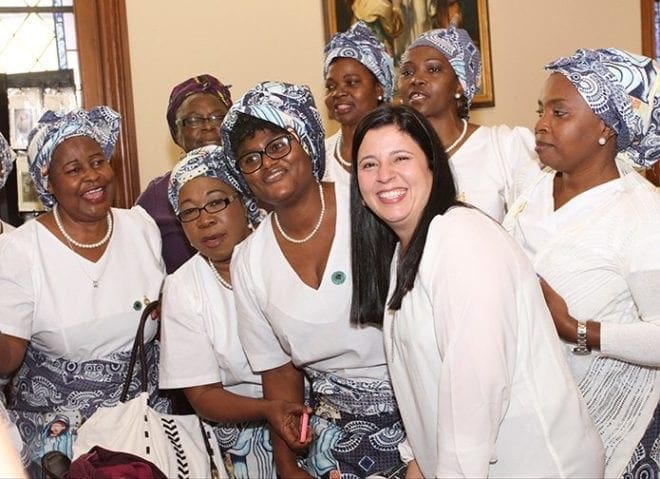 Monica Plew, front row, right, a parishioner at St. Brendan the Navigator Church, Cumming, and 2015 Father Bruce Wilkinson Founders Award recipient, interacts with members of the Cameroon Catholic Women’s Association. Plew was born and raised in Colombia, South America. Photo By Michael Alexander