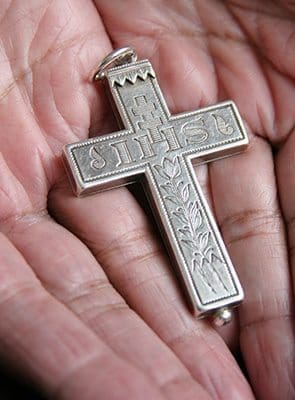 Sister Mary of the Sacred Heart holds the cross worn by the Sisters of the Visitation. The cross is a replica of the cross that St. Francis de Sales wore. Photo By Michael Alexander
